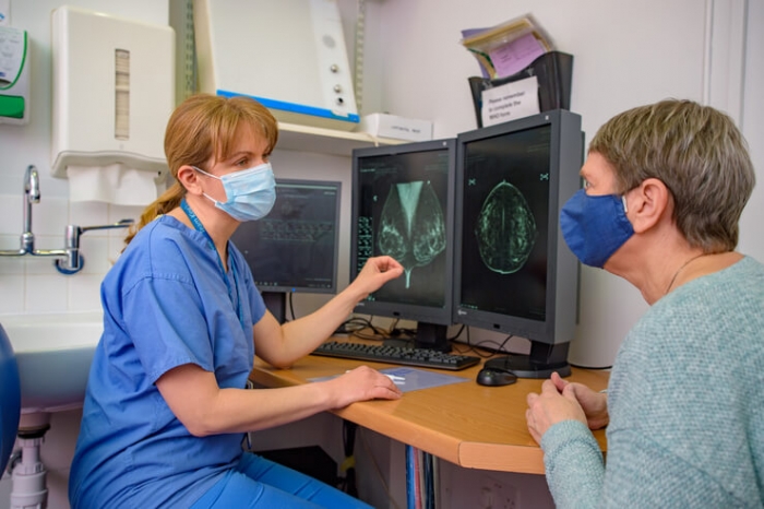 Nurse and a patient reviewing scan images