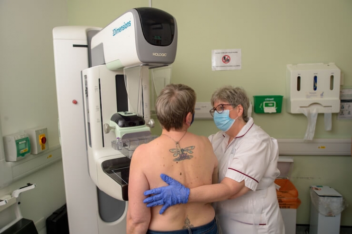 Nurse helping a patient with screening